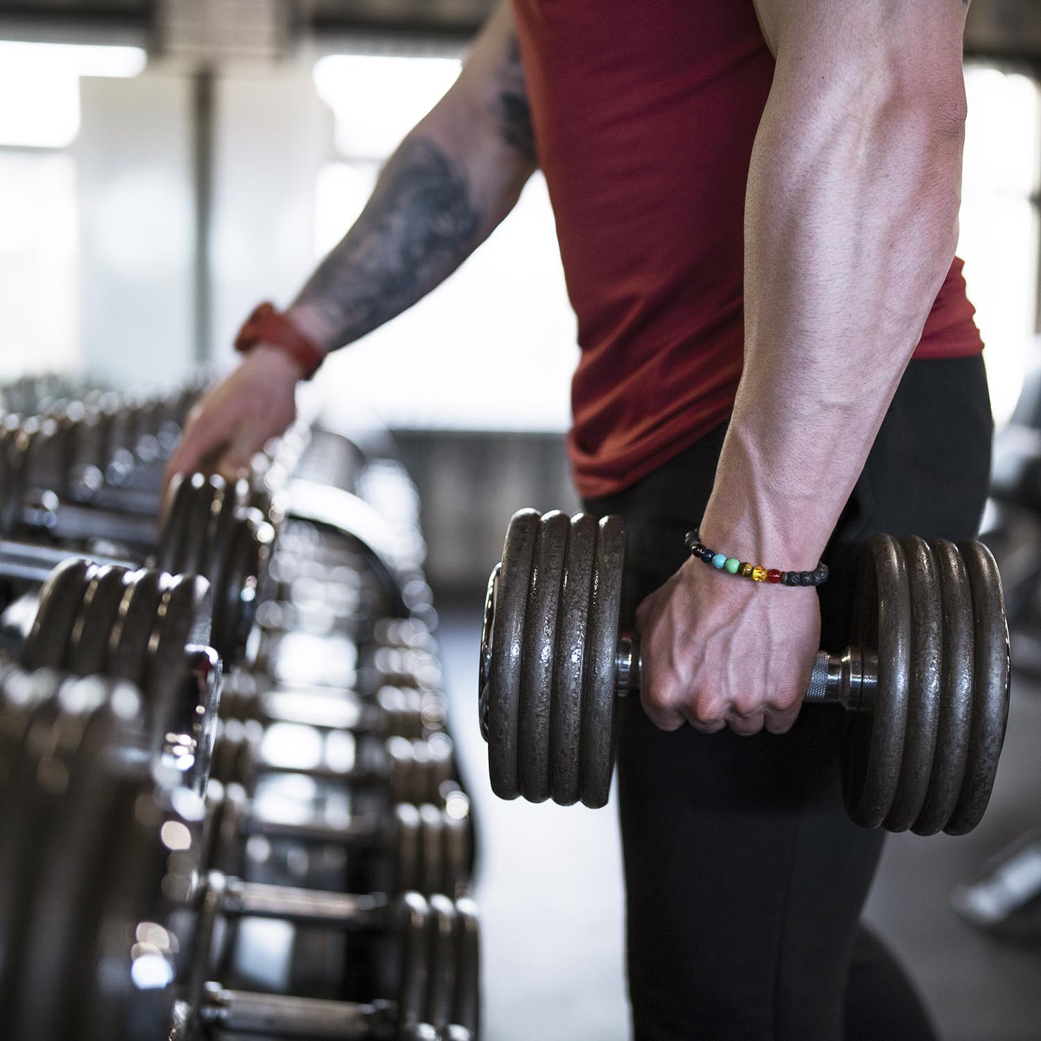 Handsome man exercise with dumbbell in the gym