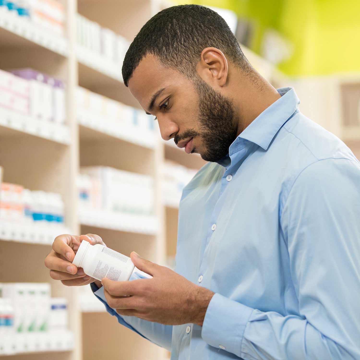 Beard Man Choosing Supplement In Drugstore