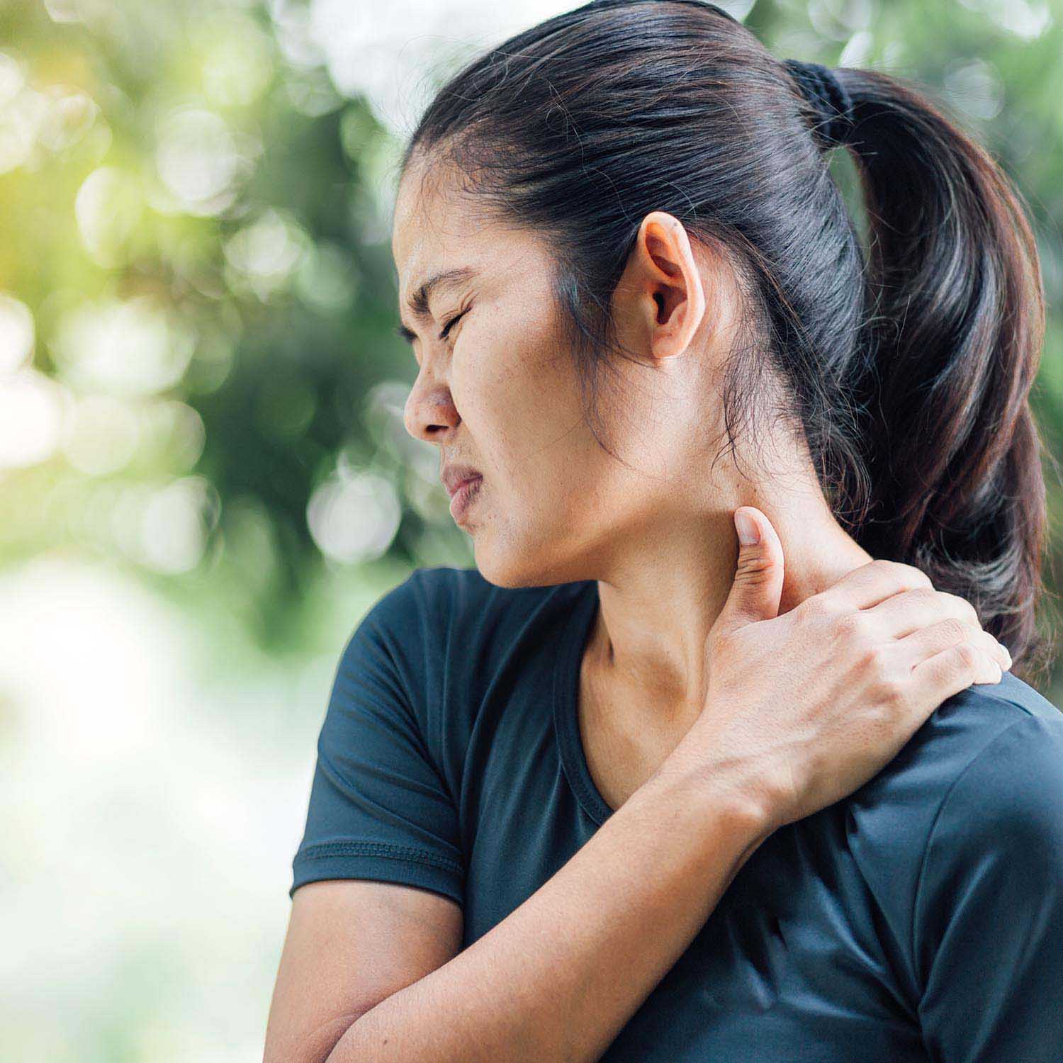 Woman rubbing neck in pain