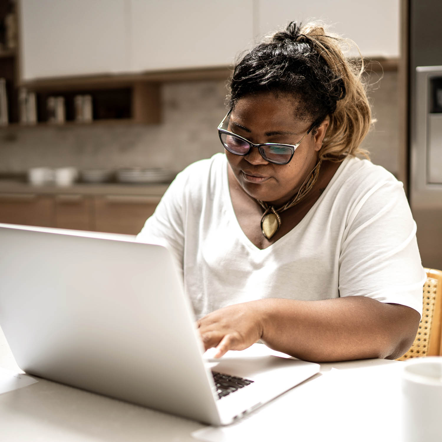 Mature woman using laptop working from home