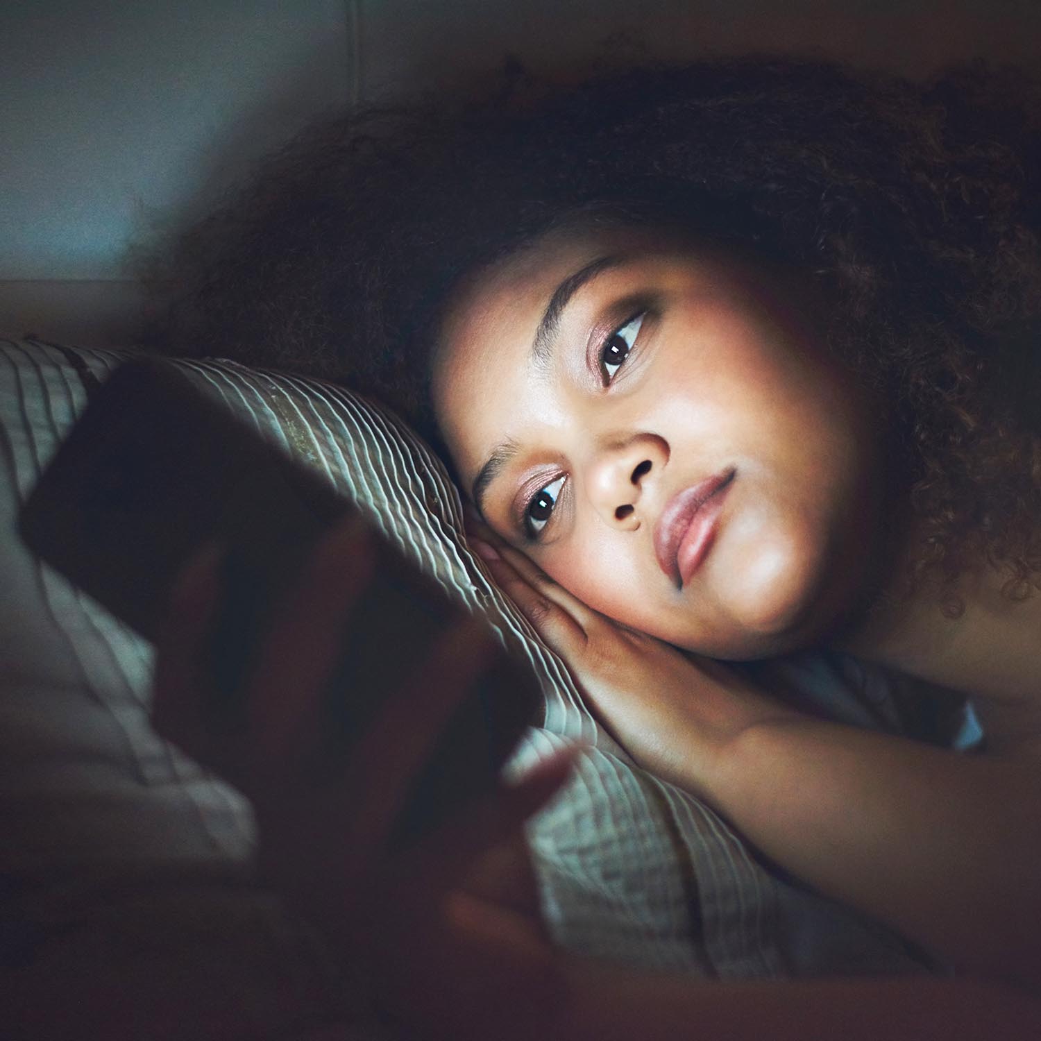 Woman looking at computer screen at night