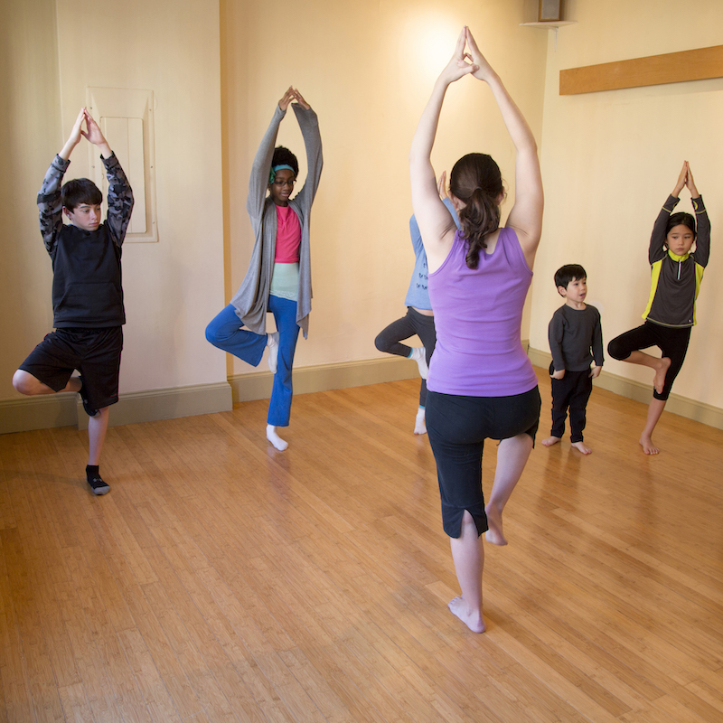 Instructor teaching children yoga