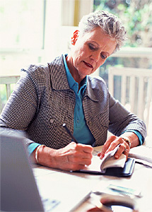 Woman signing a check.