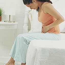 Woman holding stomach in pain.