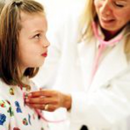 A child receives an exam from her health care provider.