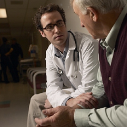 Doctor speaking to elderly man.