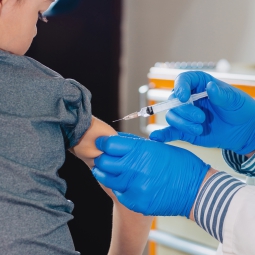 Child receiving a vaccine in the arm