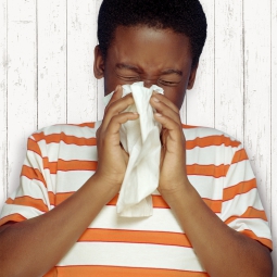 A child sneezing into a handkerchief