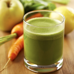 Vegetable smoothie surrounded by fruits and vegetables