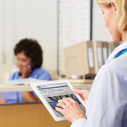 Photo of a health care provider holding an computer tablet showing the NCCIH Health Care Provider web page.
