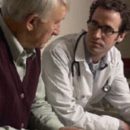 Doctor speaking to elderly man.