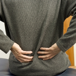 Patient holding back in pain.