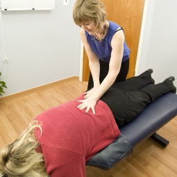 A chiropractor works on a patient.