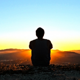 Man meditating during sunrise