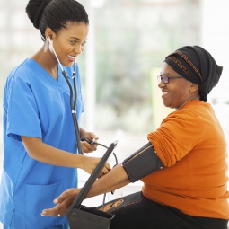 nurse taking woman's blood pressure