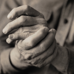 Person rubbing hands together in pain.