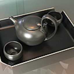Tea pot with two cups on a tray.