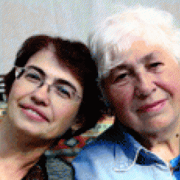 Two Women of differing ages stand side by side.