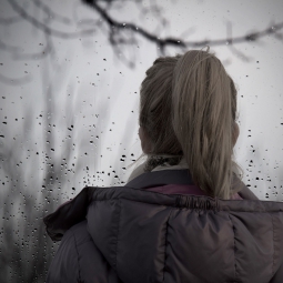 Woman looking out window.