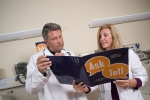 Two doctors review a folder of Time to Talk campaign material.
