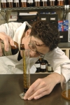 Herbalist compounding (preparing) an herbal extract.