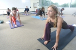 Yoga instructor demonstrates a lunge pose.