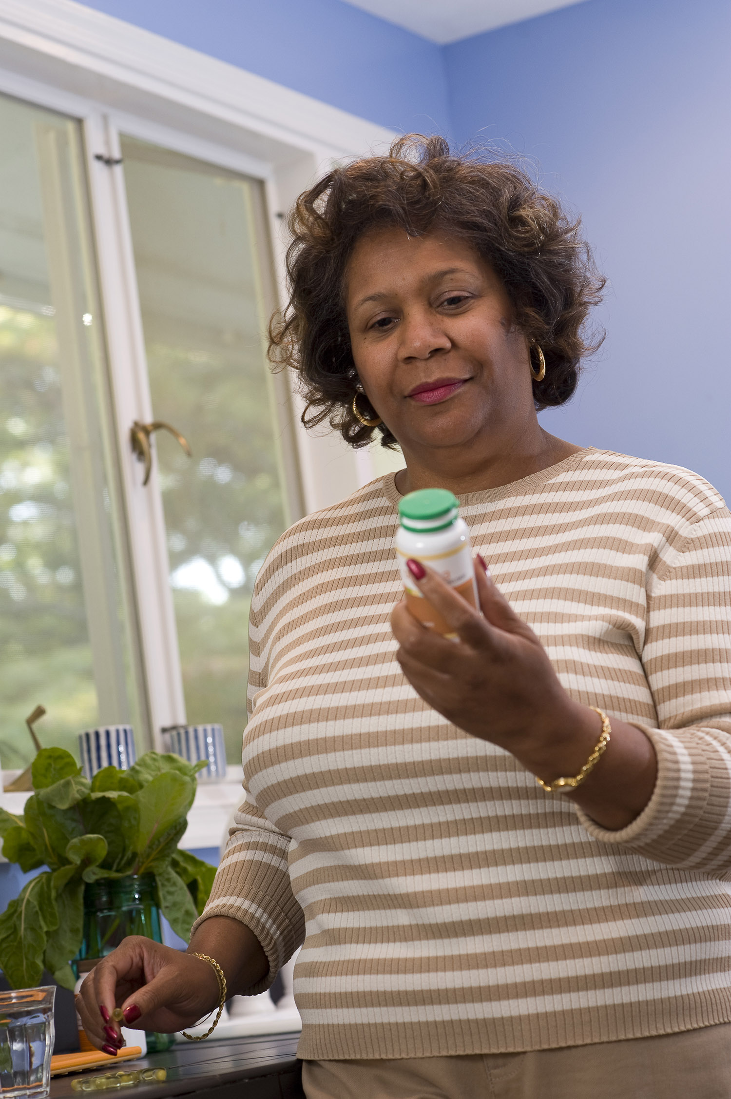 Woman examining a pill bottle.